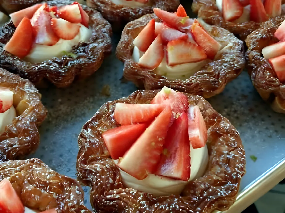 A tray of strawberry and cream tartlets